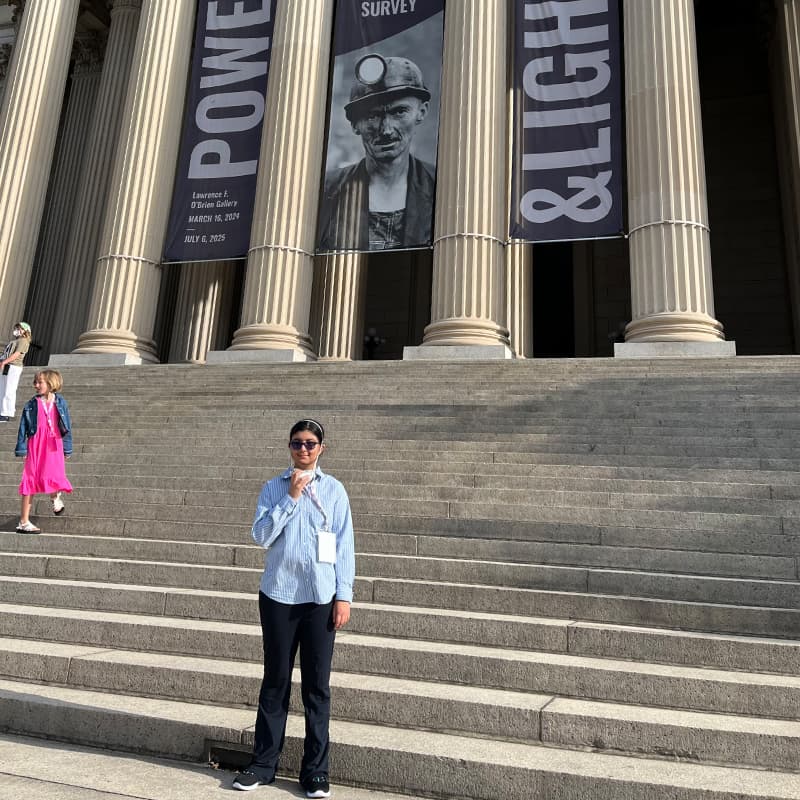 Shreya Singh posing on the steps of the National Archives building in Washington, DC