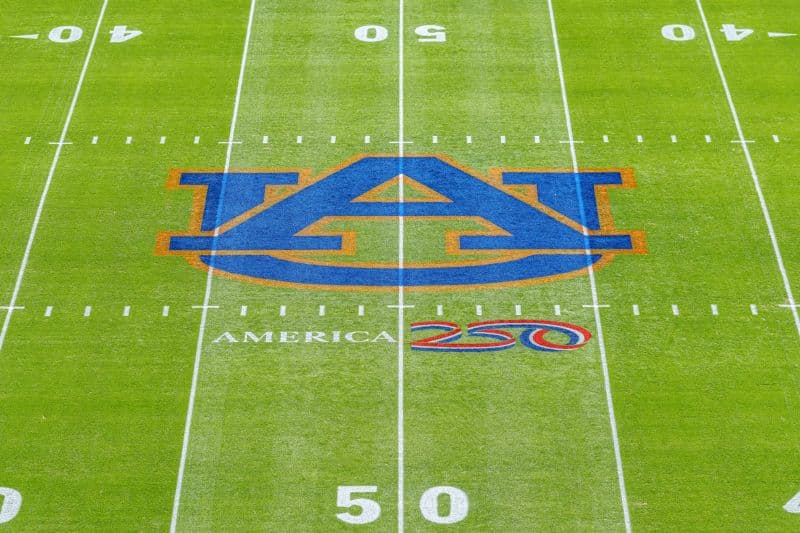 Image of the Auburn logo on a football field with the America250 logo underneath it