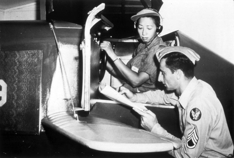 Hazel Ying Lee reviews her performance with an instructor after a training session. US Air Force photo.