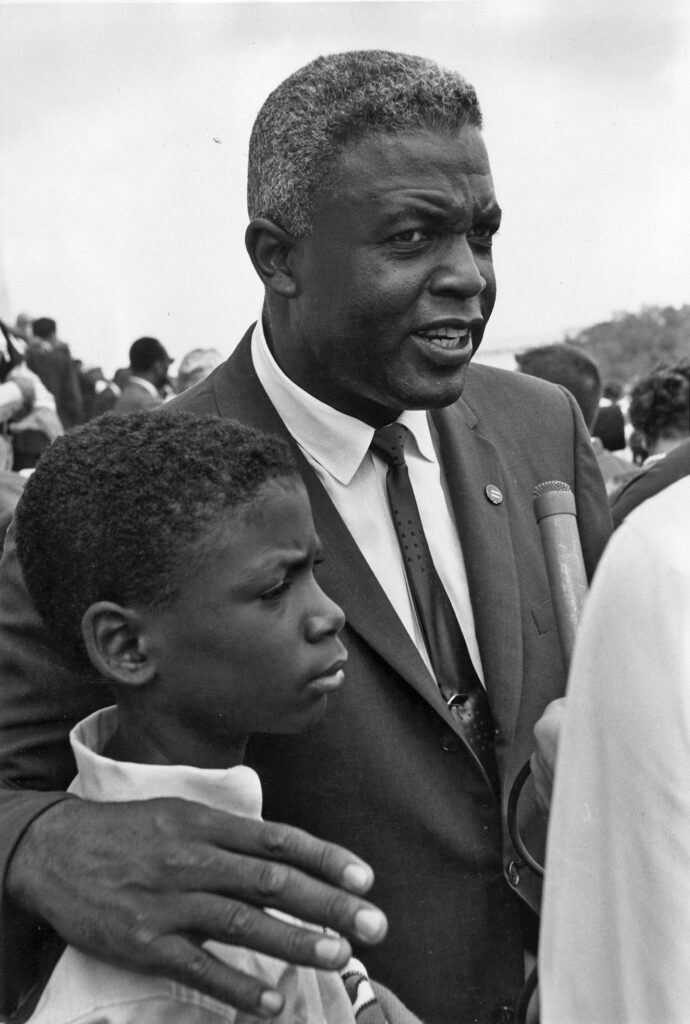 Jackie Robinson with his hand around his son's shoulder in Washington, DC.