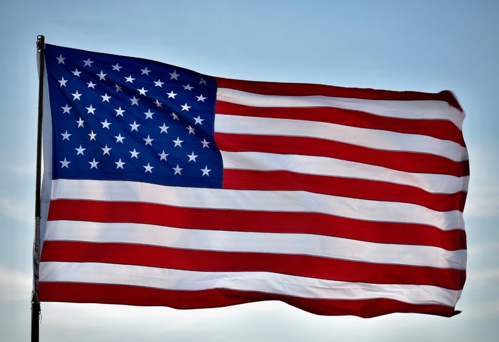 The American flag with 13 red and white stripes and 50 white stars.