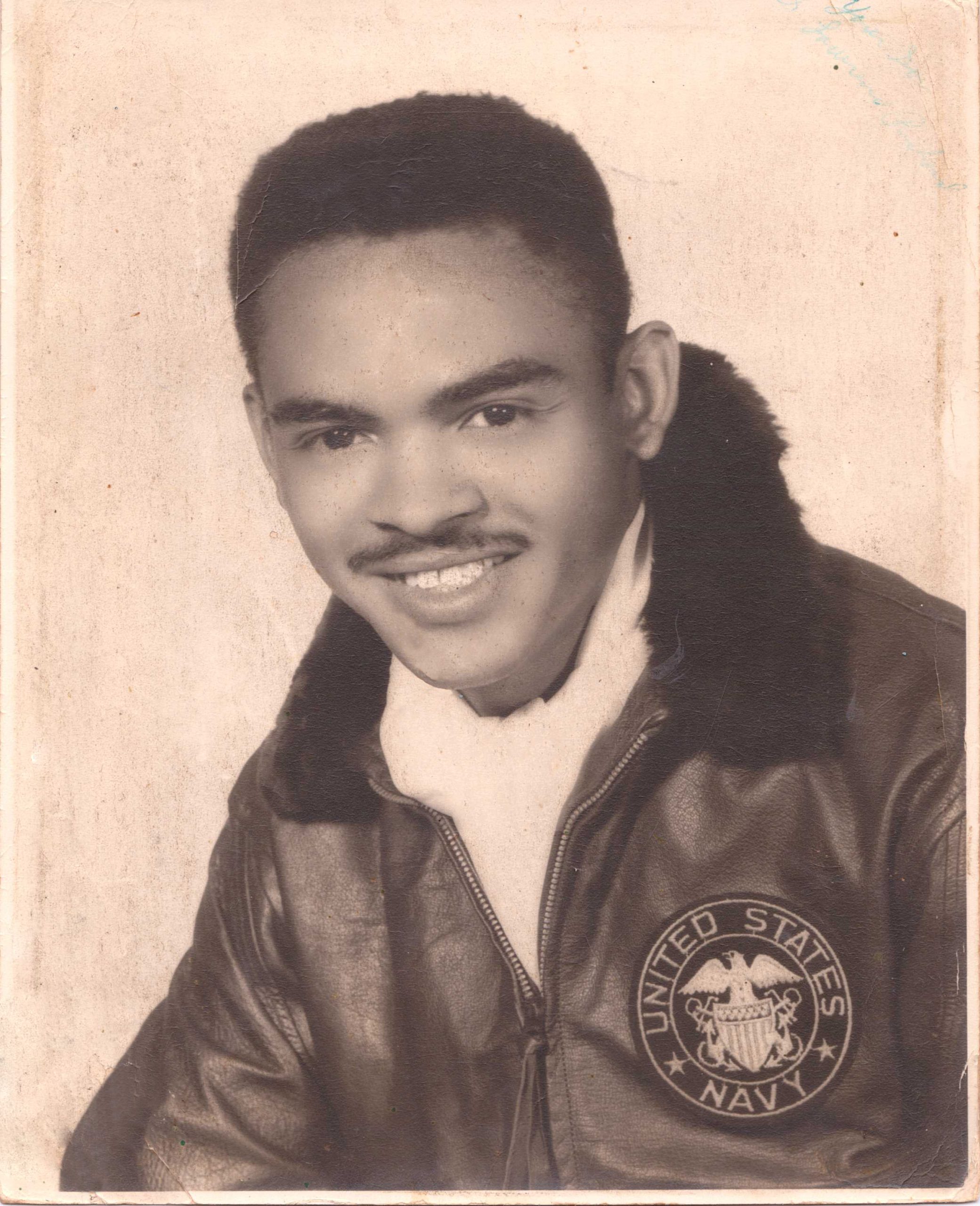 Black Navy veteran wearing a jacket and a scarf