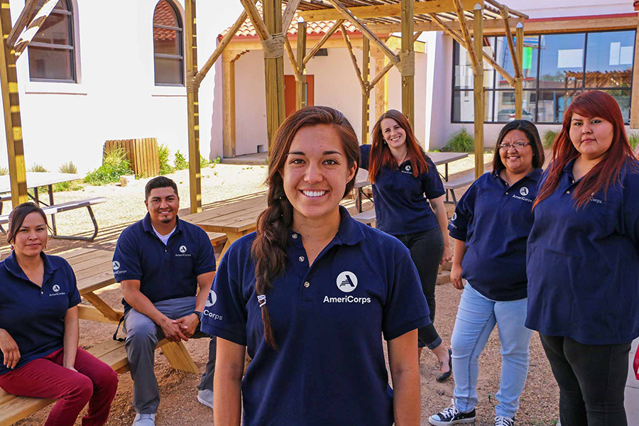 AmeriCorps team members pose together, promoting volunteerism and national service.