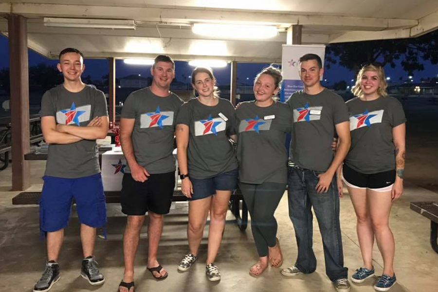 Group of young volunteers in Blue Star Families shirts support a local community outreach program.