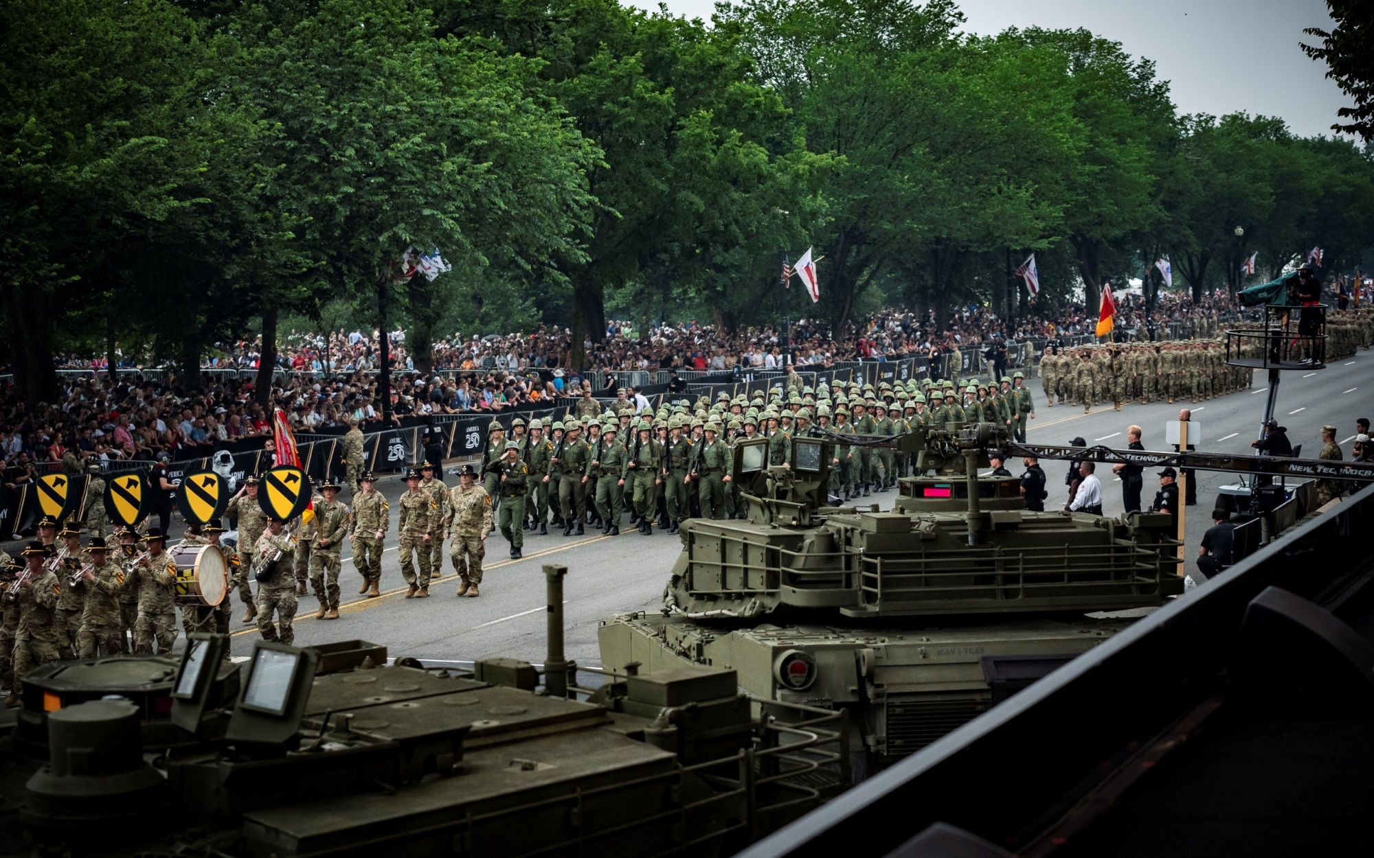 Soldiers on parade in Vietnam-era uniforms, including 1st Cavalry Band and 25th Infantry Division