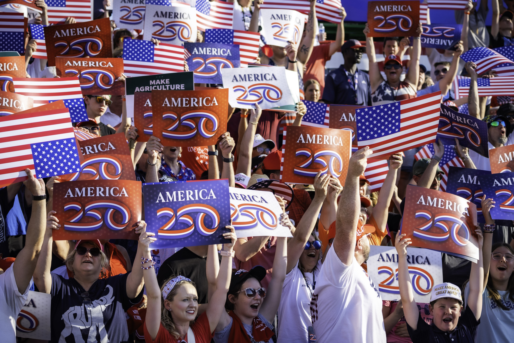 America250 signs in the crowd at the America250 Iowa event on July 3 2025